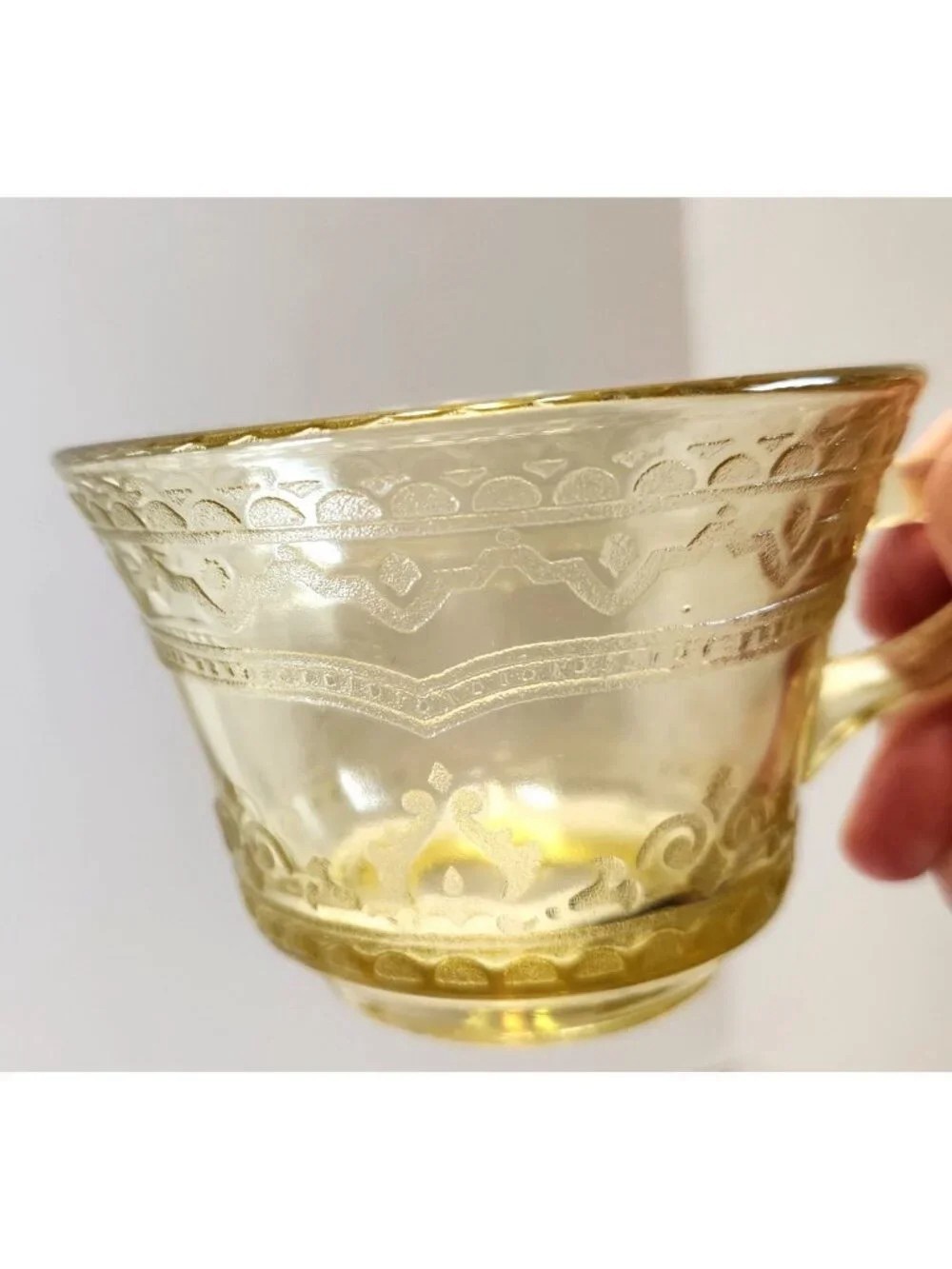 Elegant Amber Glass Teacup with Etched Decorative Pattern